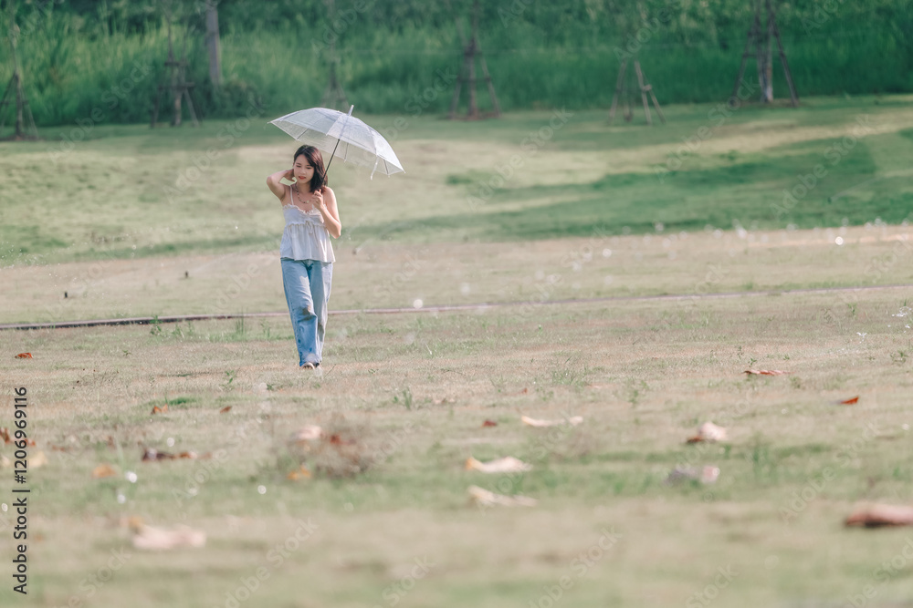 A young woman strolls elegantly with a parasol across a serene landscape A young woman strolls elegantly with a parasol across a serene landscape