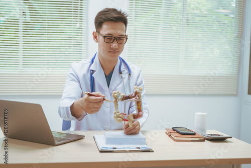 Male doctor treating intestinal diseases at a hospital table, discussing intestinal disease models, diagnosing gastritis ileitis,appendicitis, colon cancer,providing treatment plans and patient care photo