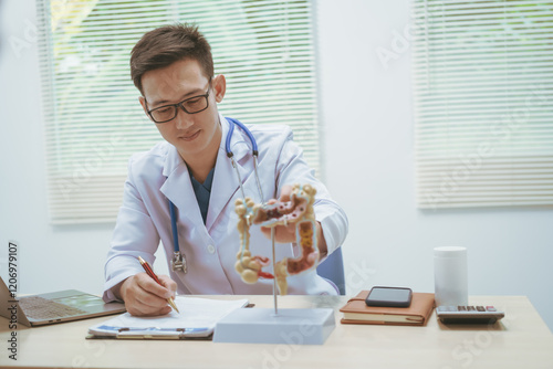 Male doctor treating intestinal diseases at a hospital table, discussing intestinal disease models, diagnosing gastritis ileitis,appendicitis, colon cancer,providing treatment plans and patient care photo