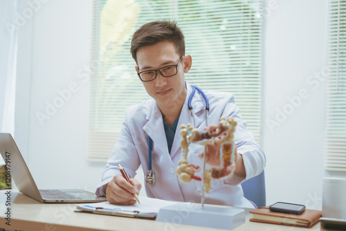 Male doctor treating intestinal diseases at a hospital table, discussing intestinal disease models, diagnosing gastritis ileitis,appendicitis, colon cancer,providing treatment plans and patient care photo