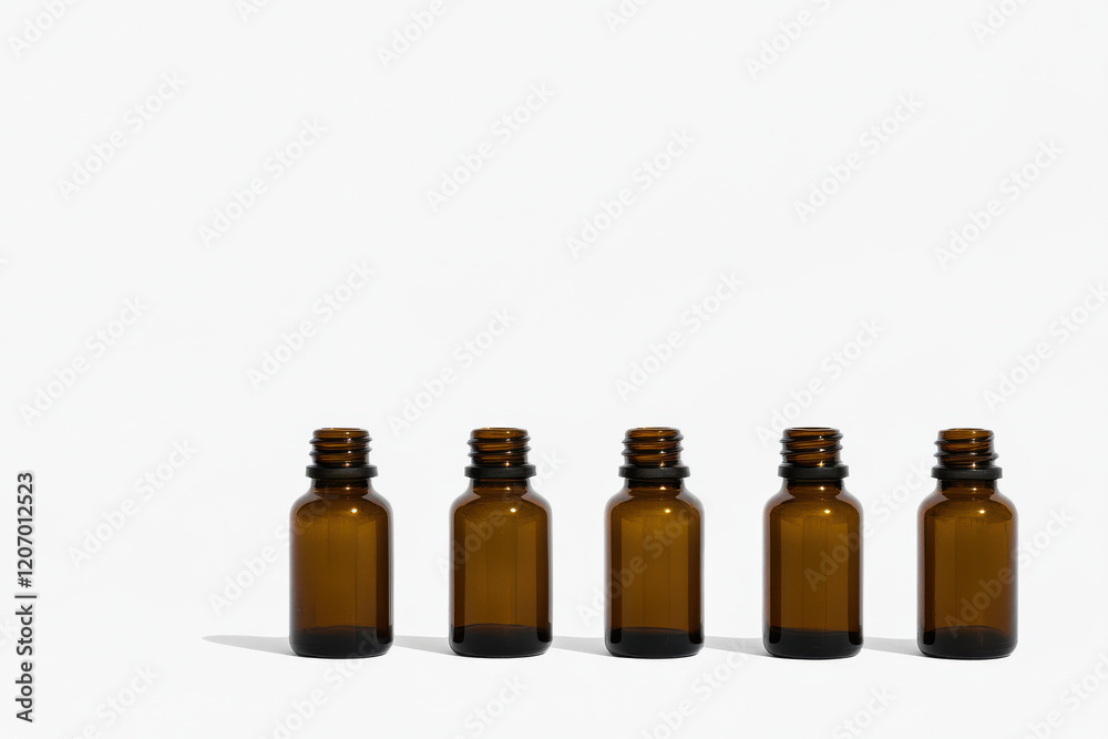 A row of five brown bottles with lids