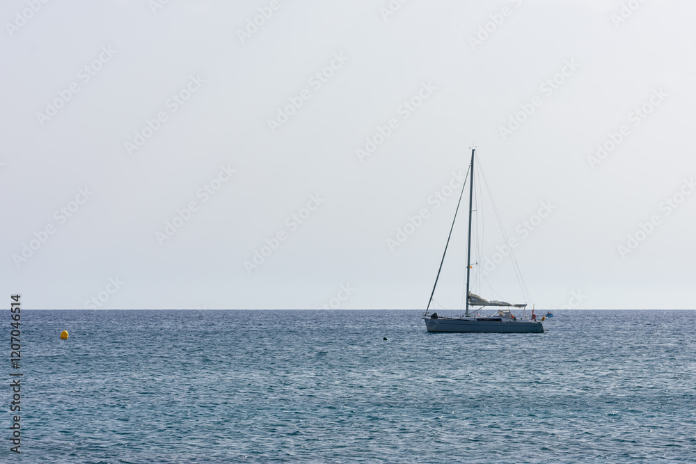 sailboat sailing on a calm sea on a sunny day sailboat sailing on a calm sea on a sunny day