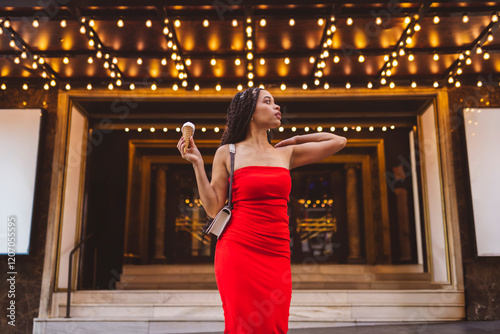 Woman posing with ice cream cone at street photo