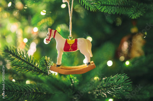 Rocking horse toy hanging on Christmas tree photo