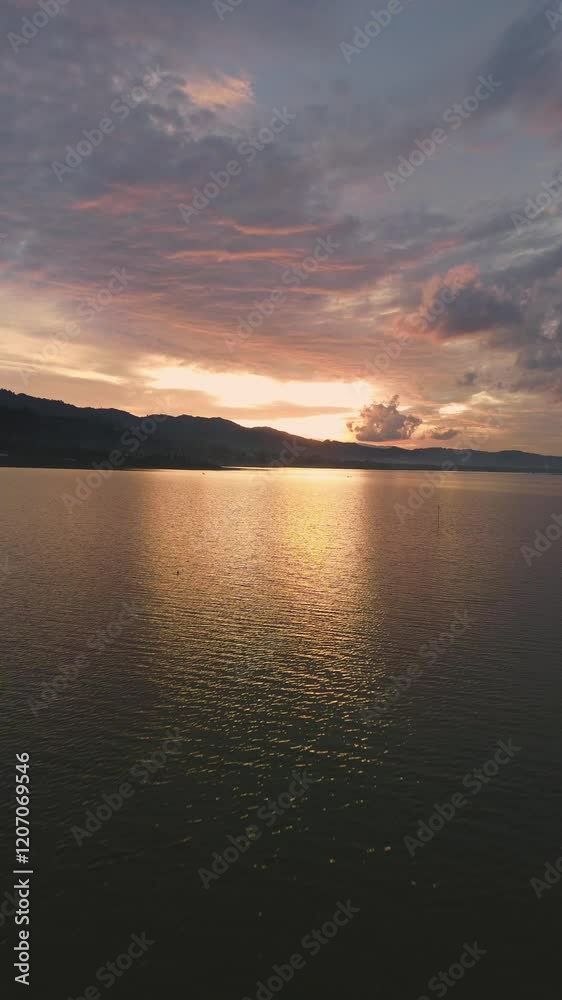 Aerial view of Sunset over the lake with clouds and mountains in the background. Aerial view of Sunset over the lake with clouds and mountains in the background.