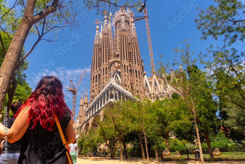 Tourists admiring sagrada familia basilica in barcelona, spain