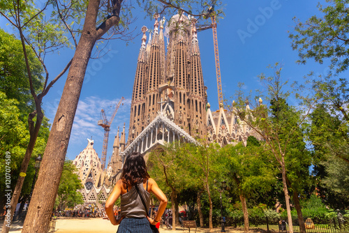 Tourist admiring sagrada familia basilica in barcelona, spain