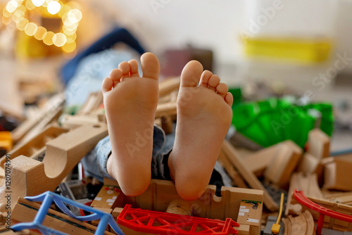 Wallpaper Mural Child, cute boy, playing with toys in a playroom, focus on his feet Torontodigital.ca