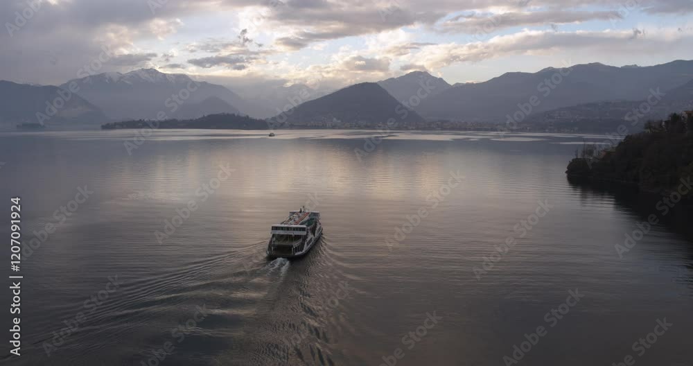 Aerial view of passenger boat and sunset on lake Maggiore, Lombardy, Italy Aerial view of passenger boat and sunset on lake Maggiore, Lombardy, Italy