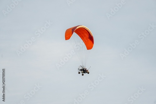 Paramotor soaring against clear sky