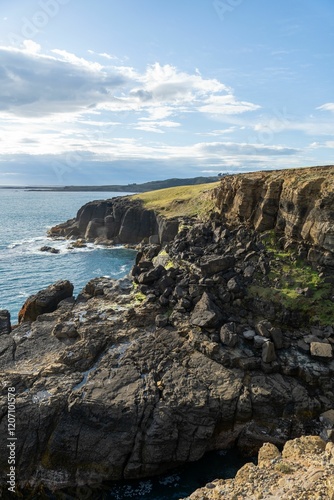 Wallpaper Mural Scenic coastal cliffs with rocky formations under a partly cloudy sky. Torontodigital.ca