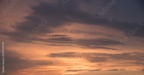 orange sky with grey cloud bands, at sunset