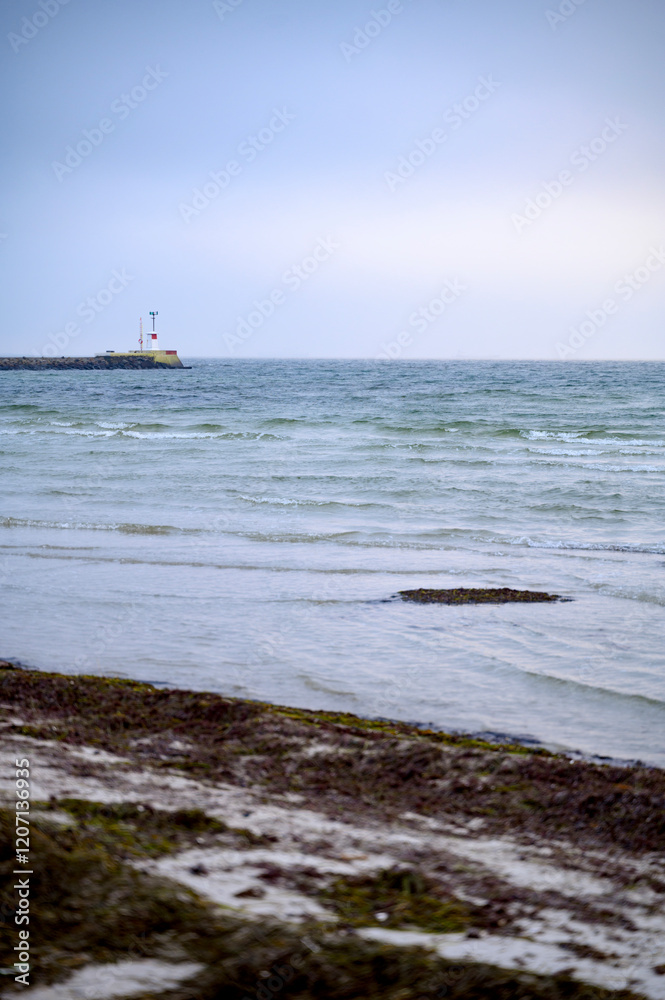 A lighthouse far away in the sea Lomma beach Sweden 2025 A lighthouse far away in the sea Lomma beach Sweden 2025