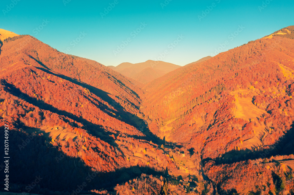 Panoramic view from above of colorful slopes of mountains on a sunny autumn day. Beautiful landscape. Carpathian mountains, view from Prislop Pass, Ukraine