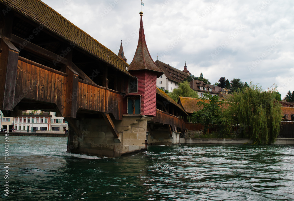 The Spreuer Bridge is one of two covered wooden footbridges spanning the Reuss River in the city of Lucerne, Switzerland. Photograph taken on a cloudy spring day.
The Spreuer Bridge is one of two covered wooden footbridges spanning the Reuss River in the city of Lucerne, Switzerland. Photograph taken on a cloudy spring day.