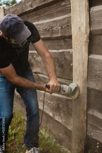 Rough cleaning and blanching of old boards - renovation of garden fence slats - rough male labor