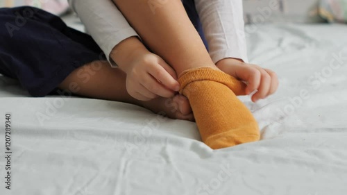 socks while sitting on bed, preparing for a restful night's sleep