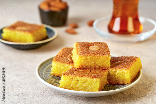 Middle eastern traditional semolina cake basbousa , namoora, hareesa served with tea