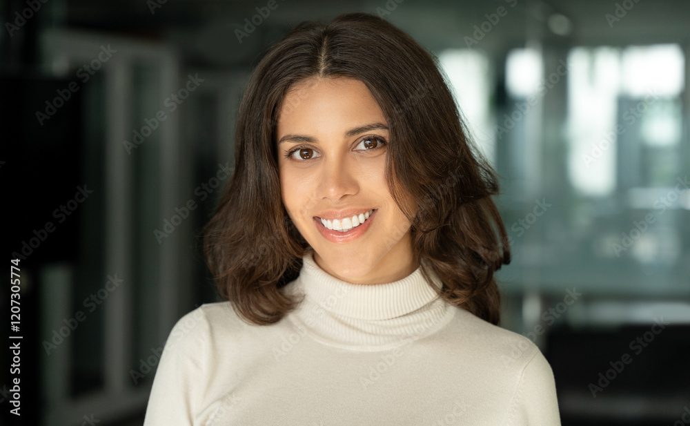 Closeup headshot face portrait of beautiful successful hispanic young business woman looking confident at camera. Smiling latin or eastern middle age female ceo leader businesswoman standing in office