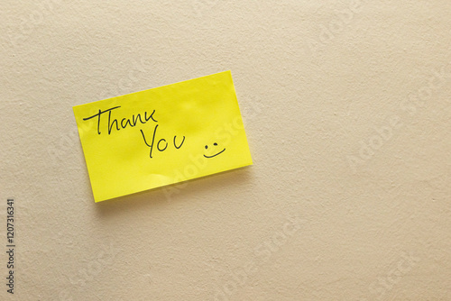 A yellow sticky note with the word 