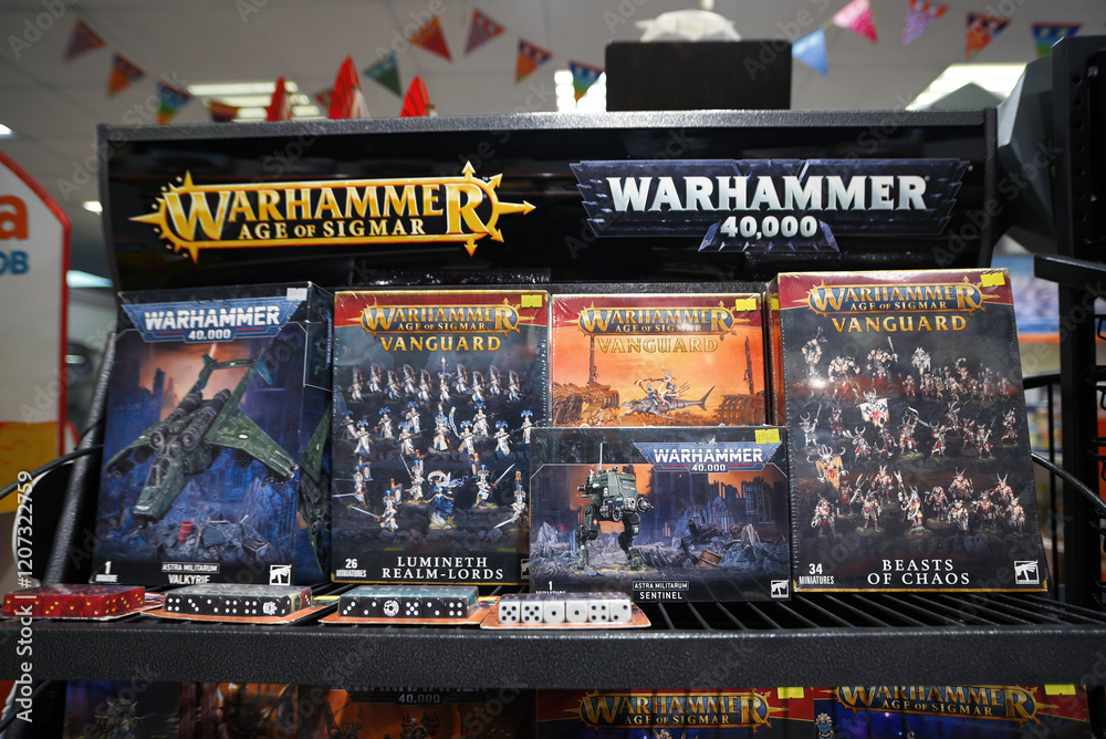 Minsk, Belarus. Nov 8, 2024. Store shelf with Warhammer 40,000 and Age of Sigmar boxed sets, dice, and game pieces. Warhammer 40000 games on display. Tabletop war gaming collection featuring Warhammer