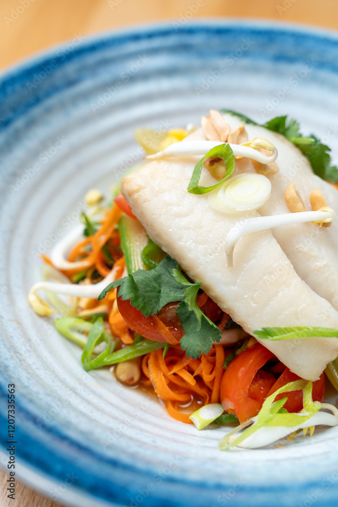 modern restaurant dish white cod fish fillet on fresh steamed vegetable light lunch bowl