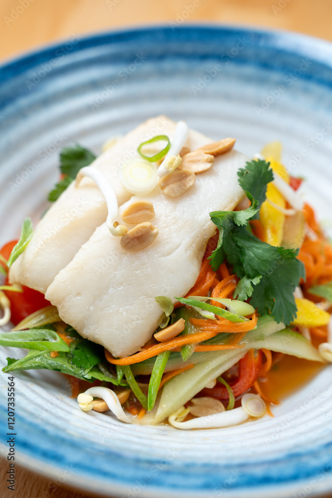 modern restaurant dish white cod fish fillet on fresh steamed vegetable light lunch bowl