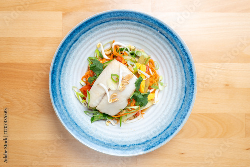 Obraz na płótnie modern restaurant dish white cod fish fillet on fresh steamed vegetable light lunch bowl w salonie