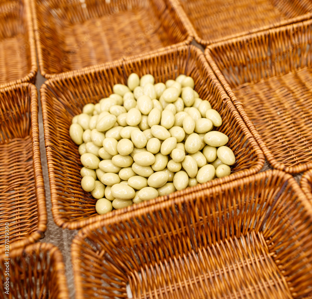 A basket of nuts is sitting on a table A basket of nuts is sitting on a table