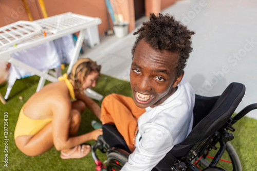 Joyful moment of friendship and support on a sunny day at surf camp photo
