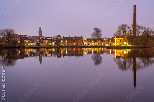 Village of Halfweg in Province North Holland, view of residential neighbourhood in the evening mirrored in the canal photo