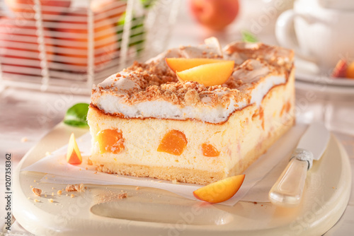 Homemade peach cheesecake served on bright kitchen.
