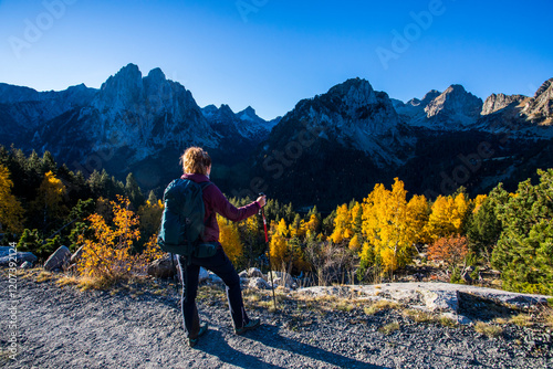 Young hiker woman in autumn in Aiguestortes and Sant Maurici National Park, Spain photo