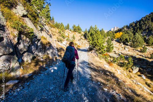 Young hiker woman in autumn in Aiguestortes and Sant Maurici National Park, Spain photo