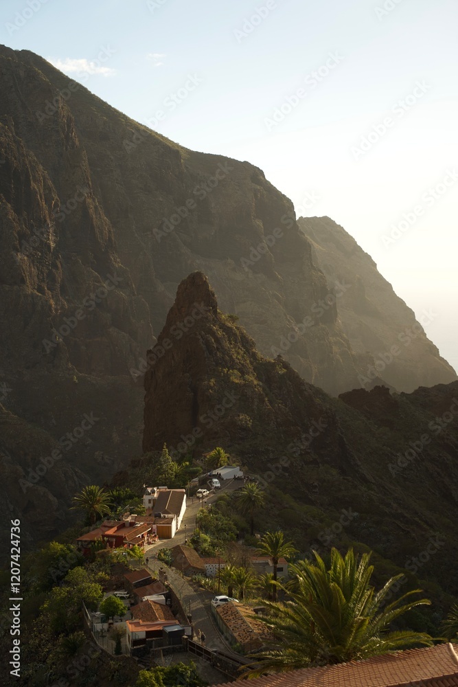 Naklejka premium Picturesque view of La Masca village in Tenerife, Spain, nestled among dramatic volcanic peaks and lush greenery under a clear blue sky.
