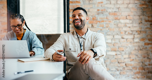 Relaxed businessman enjoying a casual office discussion with a colleague, showcasing a positive and collaborative work environment
