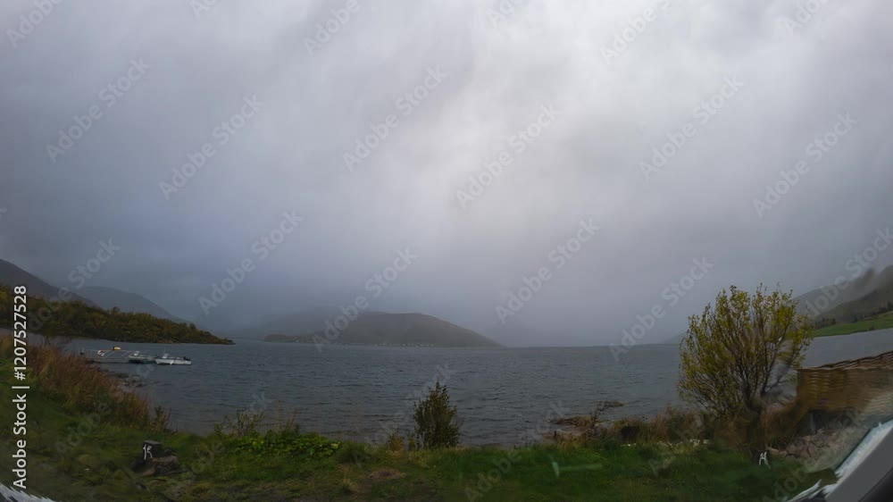 Dramatic timelapse of moving clouds over norwegian fjord Dramatic timelapse of moving clouds over norwegian fjord