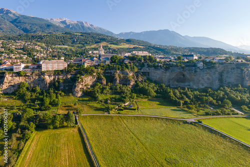 Aerial view of Le Roc cliff-top plateau and town of Embrun. Summer in Durance Valley. Hautes-Alpes, French Alps, France photo