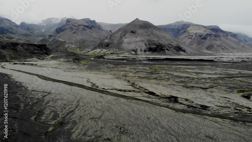 Aerial scenic view of black volcanic mountains and Vatnajokull in Iceland.