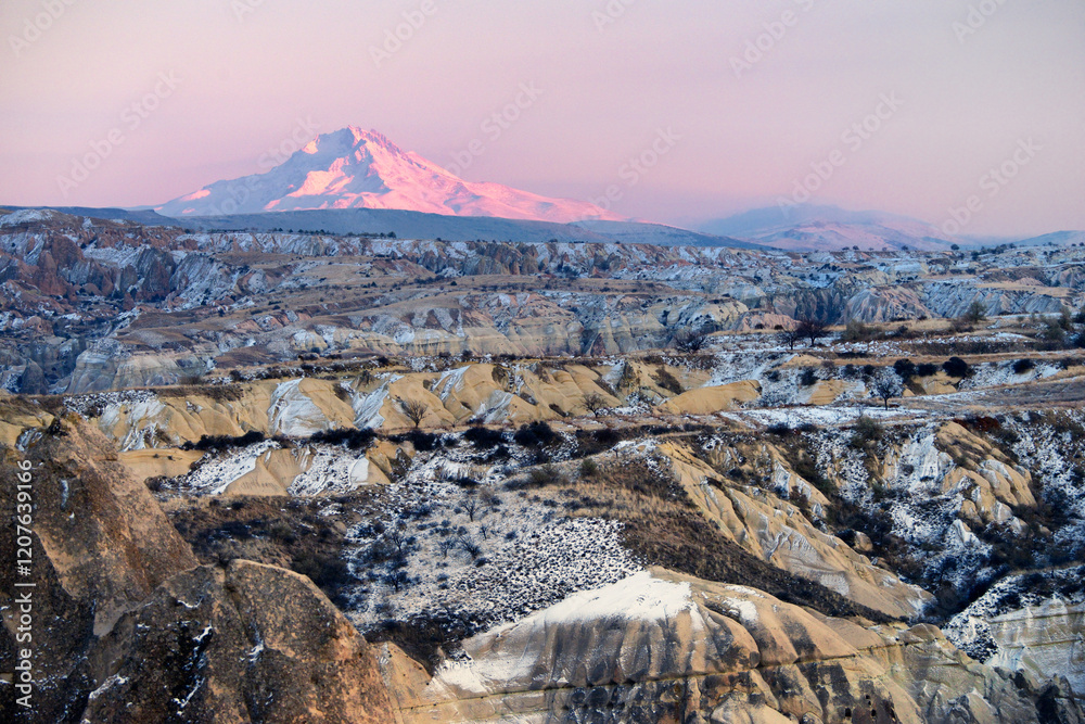 Snow covered volcanic 3916m peak of Mount Erciyes, highest mountain in central Anatolia Turkey. S.E. over gorges of Goreme