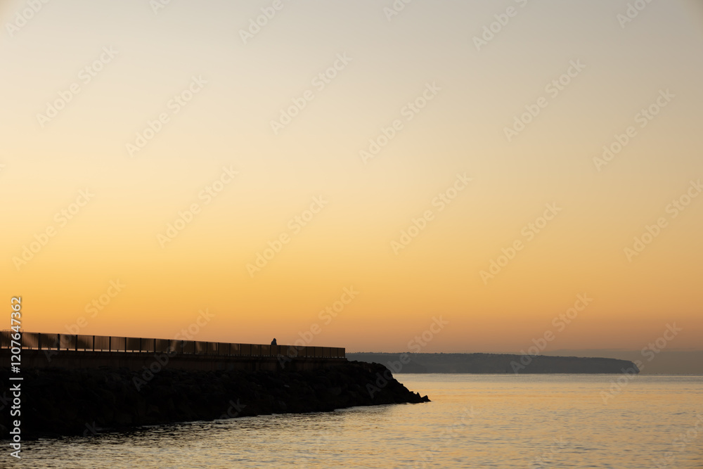 Sunrise landscape on the beach next to a pier in winter Sunrise landscape on the beach next to a pier in winter