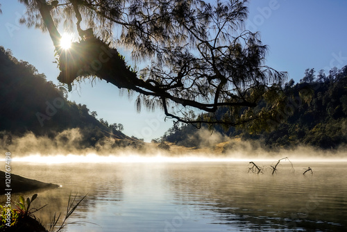 Misty morning scene on the Kumbolo lake in early morning photo