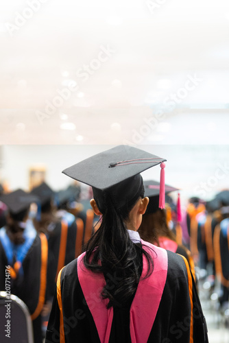 A rear view of graduates seated in rows during a graduation ceremony