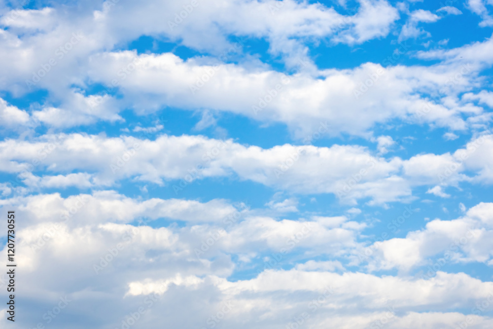 Soft, white clouds floated gracefully across the sunny blue sky, creating a beautiful background. Soft, white clouds floated gracefully across the sunny blue sky, creating a beautiful background.