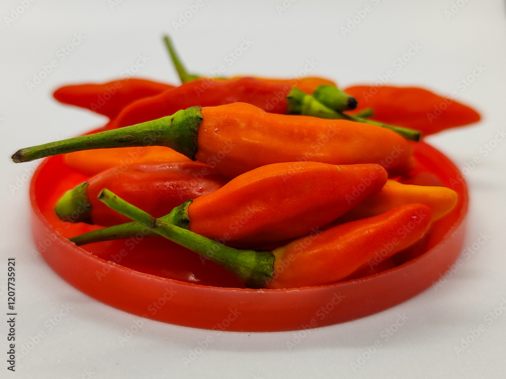 Small chili. Cayenne pepper on a red container. Small chili. Cayenne pepper on a red container.
