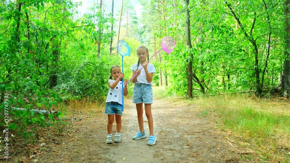 Children girls walking in the forest with device for catching butterflies footage 4k video slow motion Children girls walking in the forest with device for catching butterflies footage 4k video slow motion