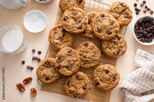 Chocolate chip cookies with pecan nuts, freshly baked cookies on a cooling rack