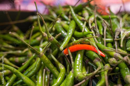 Green espelette peppers and a red one mixed