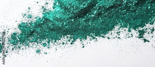 Green Glitter Powder Spread on Bright White Workspace with Open Space for Custom Text and Creative Design Elements photo