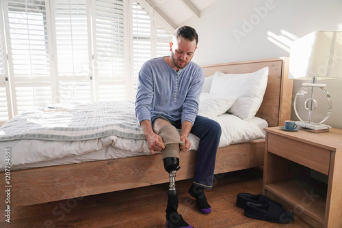 Man attaching leg prosthesis